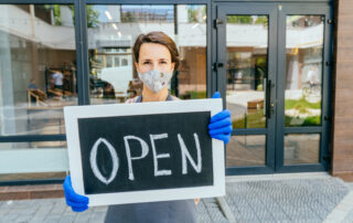 Small business woman with open sign