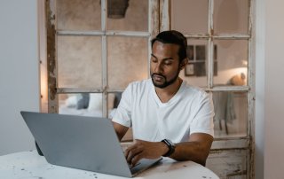 Self-employed UK business owner reviewing Making Tax Digital rules while comparing sole trader and limited company tax structures, focusing on HMRC compliance and digital tax reporting requirements.
